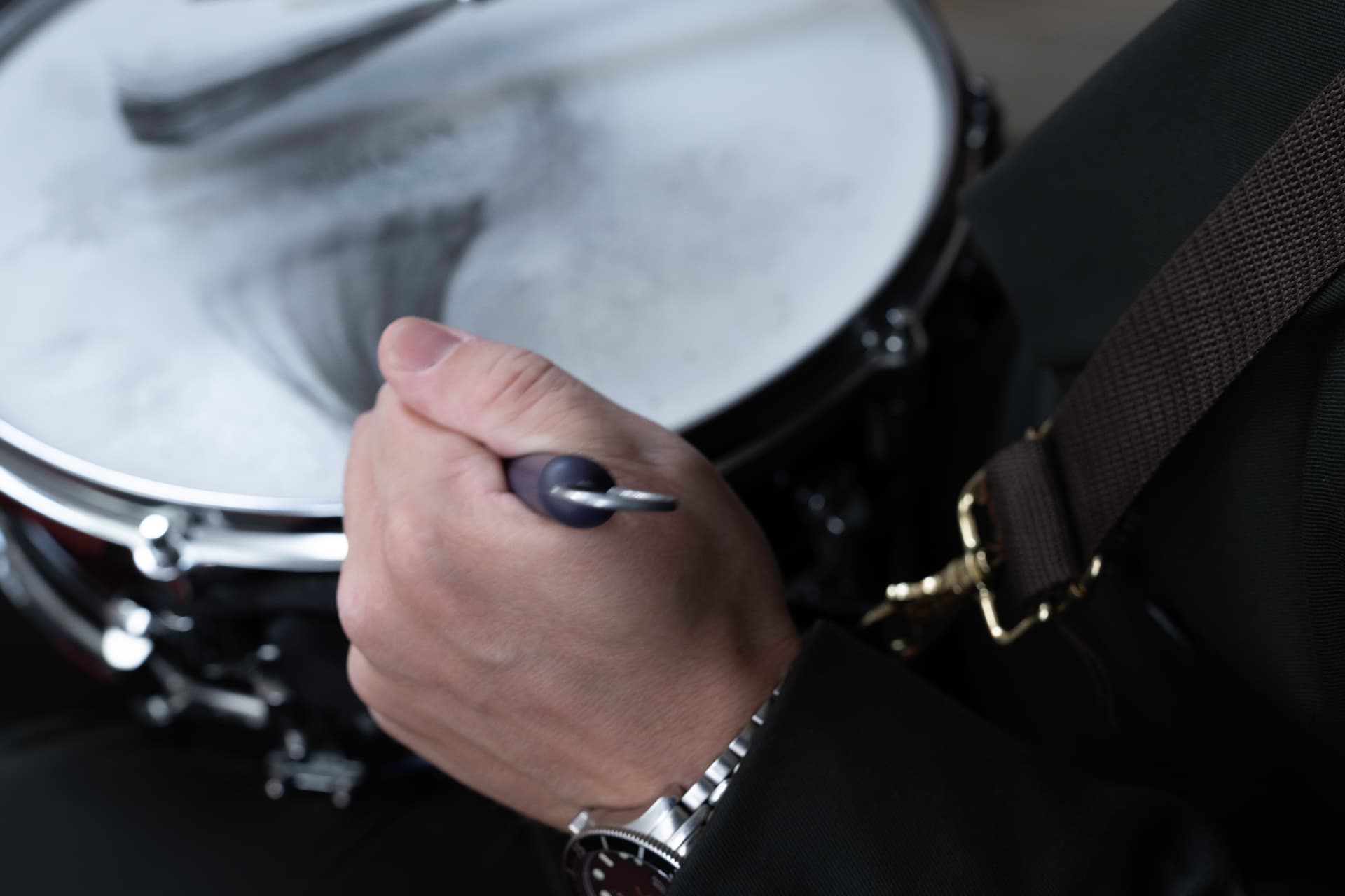 Close-up of Ludvig playing drums with brushes